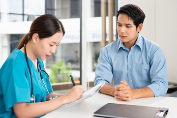 Female doctor giving a consultation to a patient and explaining medical informatics and...