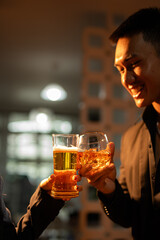 food and drink male friends are happy drinking beer and clinking glasses at a bar or pub.