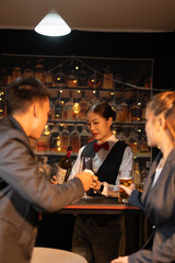 Professional female bartender preparing alcoholic drinks in a bar