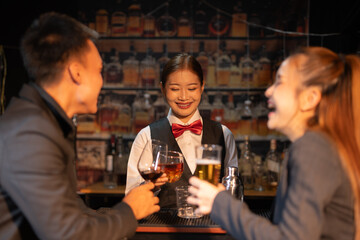 Professional female bartender preparing alcoholic drinks in a bar