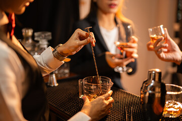  Professional female bartender preparing alcoholic drinks in a bar