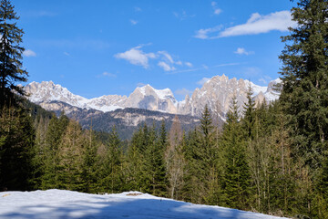 Fototapeta premium March 2025: Scenic view of snow covered mountains against sky, Fassa Valley.