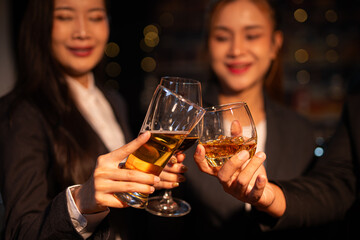 food and drink male friends are happy drinking beer and clinking glasses at a bar or pub.