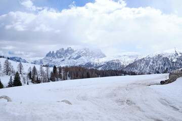 March 2025: winter landscape at Ski Area in Dolomites, Italy - Alpe Lusia. Ski resort in val di Fassa near Moena. Winter Dolomites and blue sky. Aerial view on ski slopes