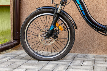 Flat tire on electric bike, pumping air into bike inner tube, bike inspection
