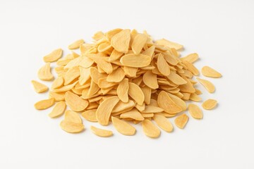 Dehydrated garlic slices displayed on a plain white surface