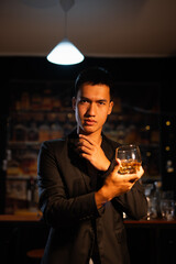 Closeup businessmen holding a glass of whiskey