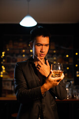 Closeup businessmen holding a glass of whiskey