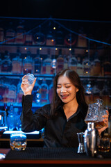 Beautiful young woman drinking alcohol at nightclub bar enjoying a pub party