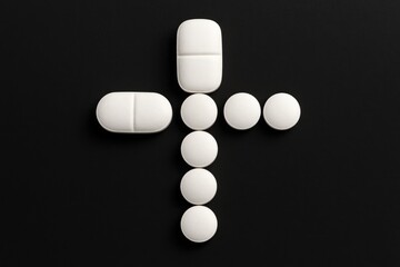 Close-up of a white pill cross on a black background