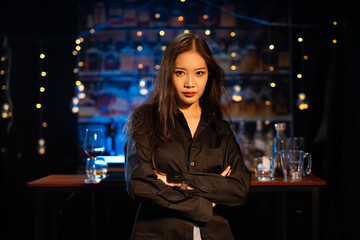 Beautiful young woman drinking alcohol at nightclub bar enjoying a pub party