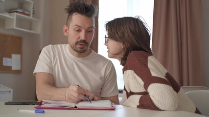 A young couple discusses home renovation and shares household tasks, capturing authentic moments of teamwork and love. Perfect for lifestyle, relationship, and DIY content