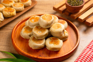 Bakpia is a flat round cookie, made from a mixture of green beans and sugar, then wrapped in flour...