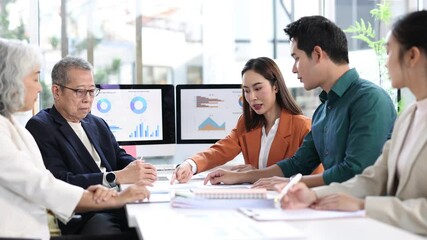 Diverse business professionals analyzing financial charts, working collaboratively on reports while discussing strategic data during corporate meeting in modern office workspace. - Powered by Adobe