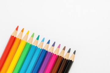 Fototapeta premium Detailed view of color pencils on a white background with ample space for text
