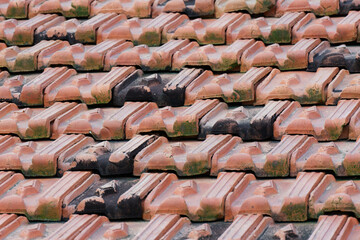Rustic terracotta roof tiles reveal a beautiful textured pattern, showcasing the enduring beauty of...