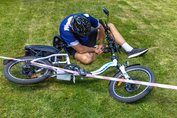 Cyclist with a broken leg and sprained ankle after an electric bike accident, the accident area is...