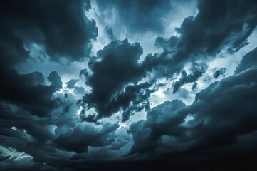 Naklejka premium A dramatic sky filled with dark heavy teal-toned storm clouds Light breaks through the dense cloud cover creating a sense of foreboding and atmospheric intensity