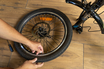 Flat tire on electric bike, pumping air into bike inner tube, bike inspection