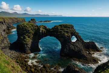 Fototapeta premium Stunning ocean view featuring a basalt arch on a volcanic cliff along the western Atlantic shoreline, perfect for nature photography.