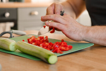 Man preparing fresh vegetables in modern kitchen, organic ingredients. Healthy meal. Cooking Food...
