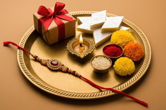 Festive Raksha Bandhan Platter Featuring Rakhis, Sweets, and Floral Decorations