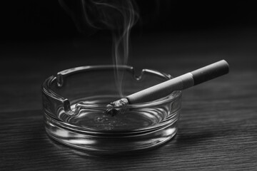 Detailed shot of a glass ashtray on a wooden surface