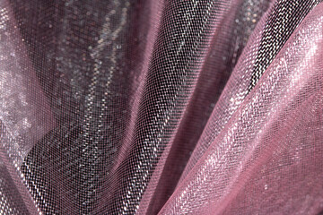 Close up of pink organza silk fabric in delicate waves for background