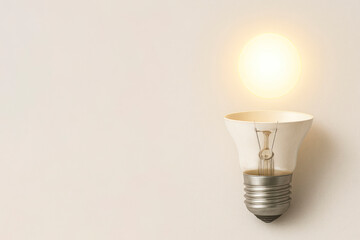 A broken light bulb from which light flies out. Space for text.