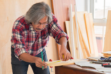 Elderly healthy people lifestyle concept, Carpenter senior man attend to making masterpiece...