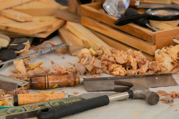 Hammer and wooden equipment for carpenter, small business or freelance carpenter or Stack of wood dust on background, sawdust in Carpentry Studio shop