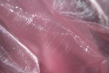 Close up of pink organza silk fabric in delicate waves for background