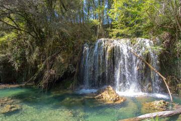 Beautiful waterfall on a bright sunny day in a famous river in Girona