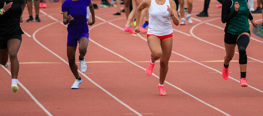 Female Runners Sprinting on a Track During Competitive Event