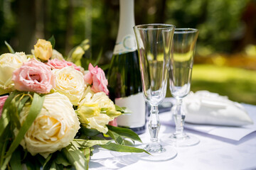 Garden celebration with flowers. A beautiful arrangement with flowers and champagne glasses set outdoors, perfect for a garden celebration.