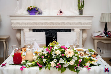 Festive table. A beautifully arranged table adorned with flowers and various dishes, creating an inviting atmosphere for guests.