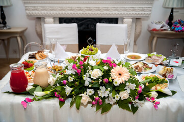 Chic table setup for a party. A beautifully arranged table features a variety of dishes and floral...
