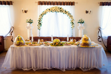 Chic buffet for special event. An inviting buffet table adorned with delicious dishes and floral...