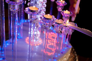 Candle lighting at celebration. Delicate candles are being lit at a festive gathering, creating a warm and inviting atmosphere filled with light.