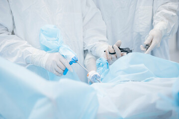 Surgeons performing surgical procedure in operating room
