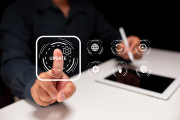 A person interacts with a digital interface, pressing an update button while using a tablet and...