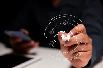 A person interacts with a digital cloud icon, symbolizing data upload and download, illustrating...