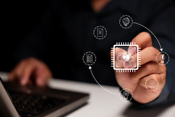 Businessman interacting with virtual cloud computing and technology icons over a laptop keyboard.