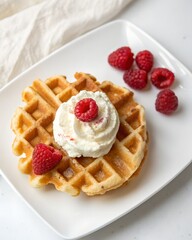 Waffle topped with whipped cream and fresh raspberries isolated on white background