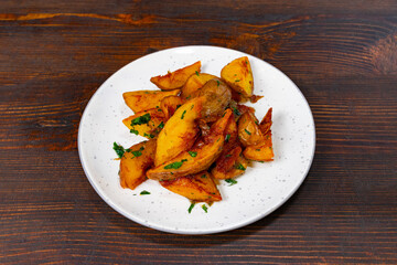 Crispy golden fried potatoes garnished with fresh herbs served on a plate for a satisfying snack experience