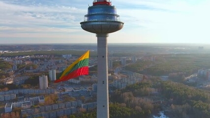 Giant tricolor Lithuanian flag waving on Vilnius television tower on the celebration of restoration of Independence of Lithuania on the 11th of March. Static view.