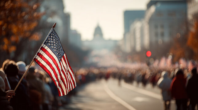 American flag waving at crowded veterans day parade with city buildings and autumn trees - Powered by Adobe