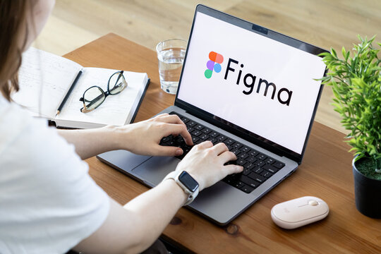 Poznan, Poland - June 15, 2025: Figma application logo on laptop, person typing, showing collaborative UIUX design in a modern digital workspace setup