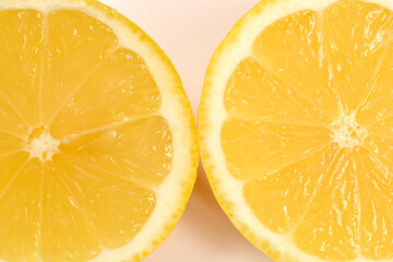 A close-up of two juicy lemon halves on a light background
