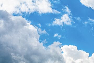 Bright blue sky with white fluffy clouds